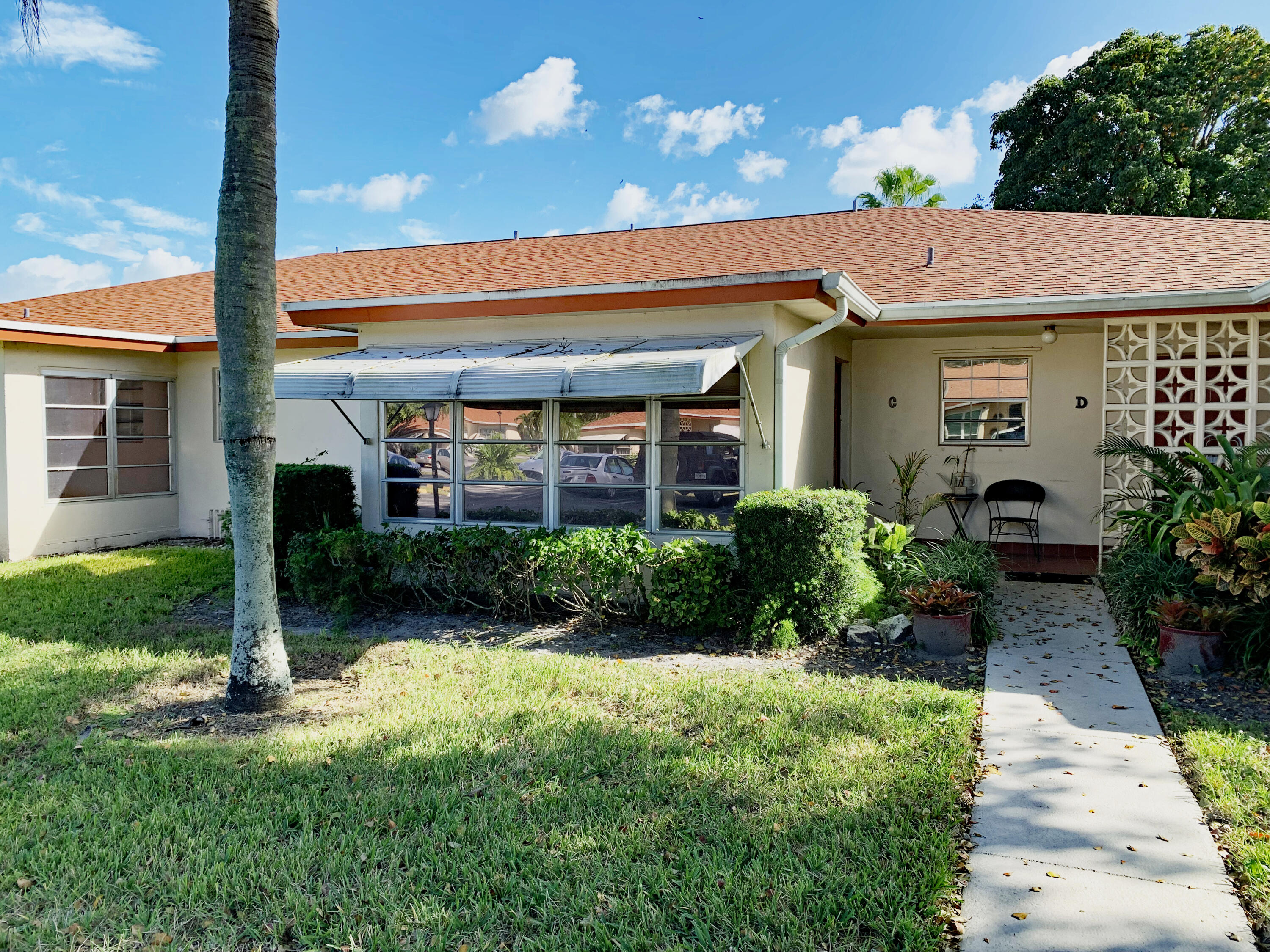 4540 Northwest 3rd Court, Unit C Delray Beach, FL 33445 - Photo 2 of 29 a view of a house with garden and plants