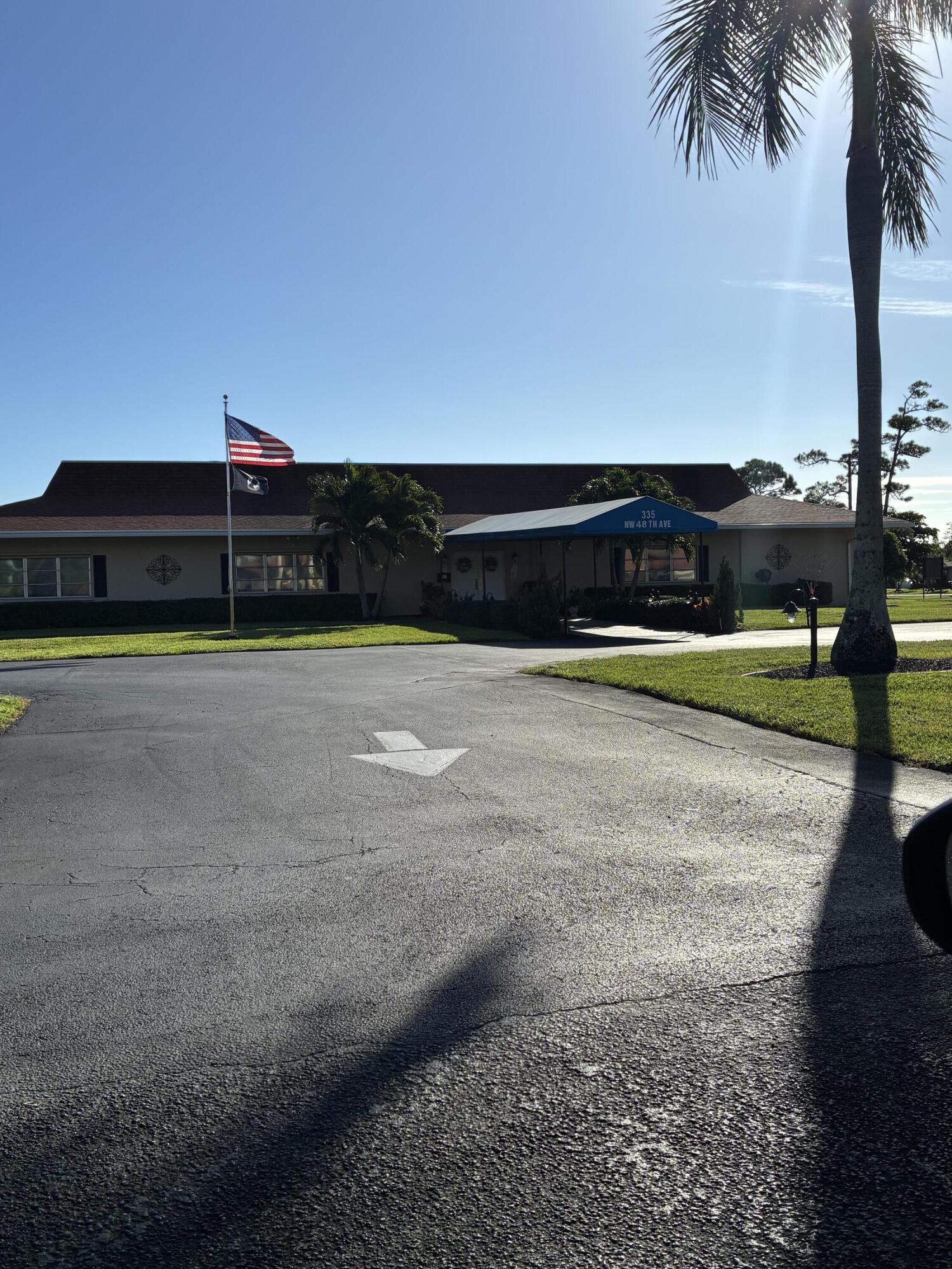 4540 Northwest 3rd Court, Unit C Delray Beach, FL 33445 - Photo 26 of 29 a view of a swimming pool with a table and chairs