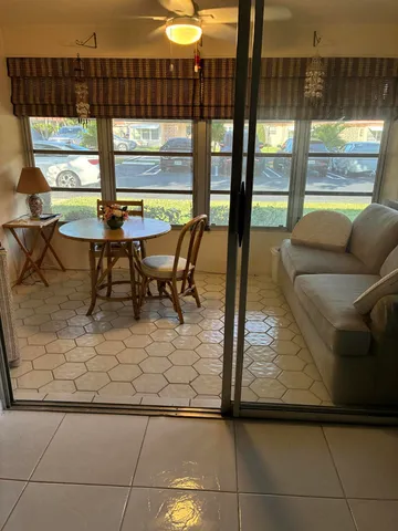 a living room with a large window and a table