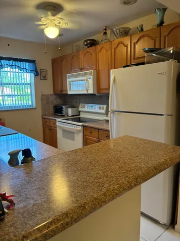 a kitchen with kitchen island a stove a sink and a refrigerator