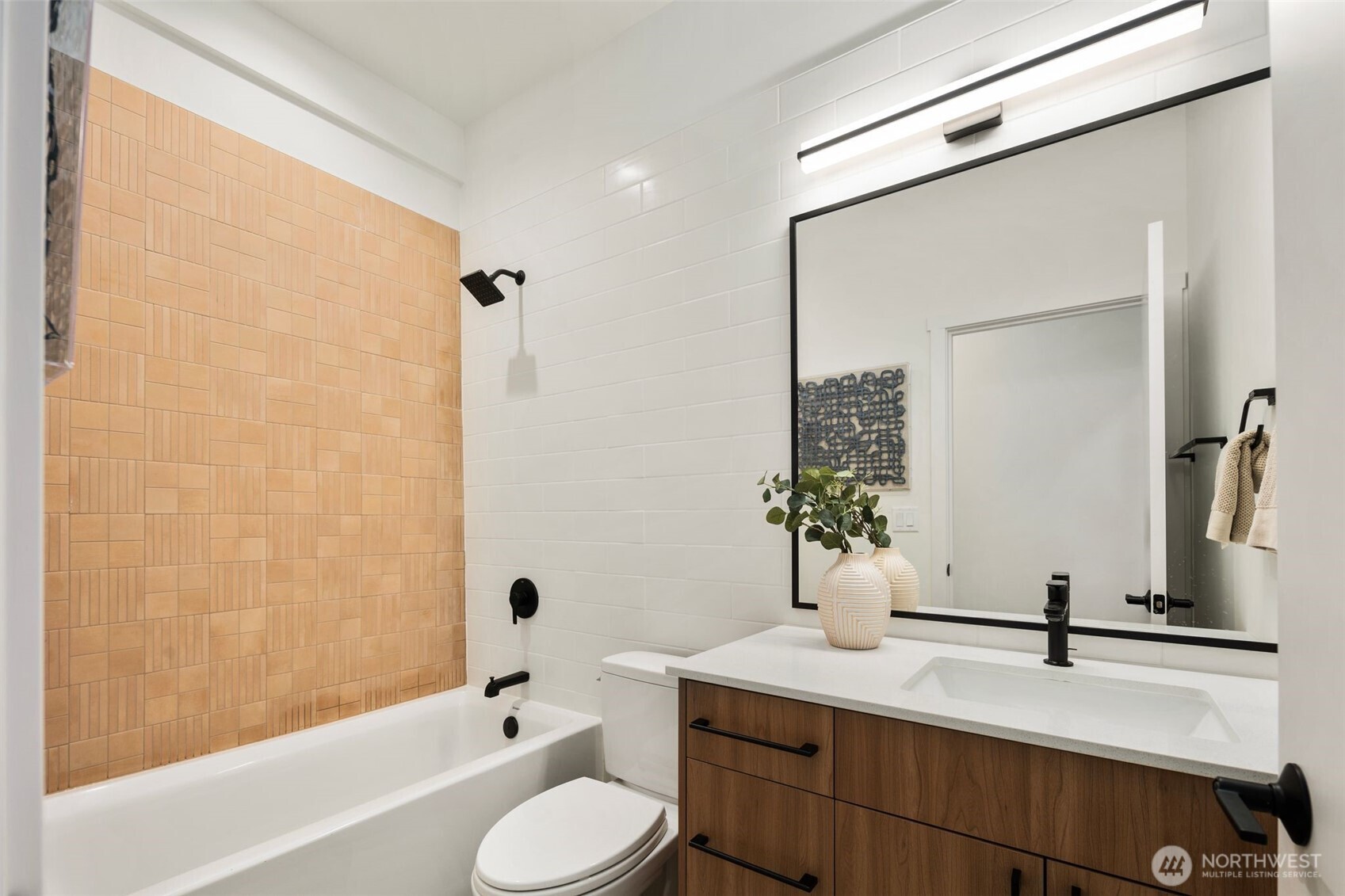 5244 23rd Avenue Southwest Seattle, WA 98106 - Photo 25 of 35 a bathroom with a tub sink toilet and mirror