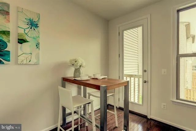 a view of a room that has a table and a chair in it