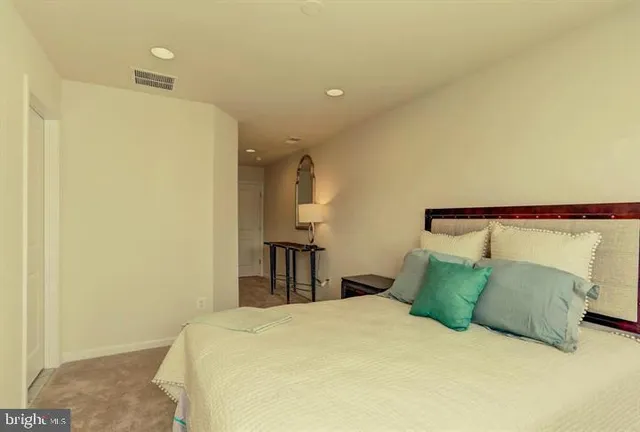 a bedroom with a bed and a night stand