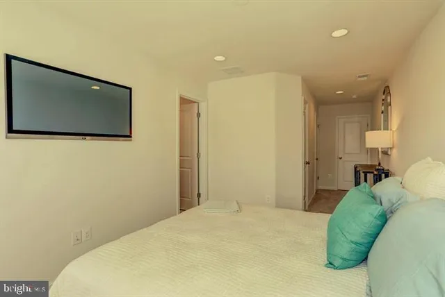 a bedroom with a bed and a painting on the wall