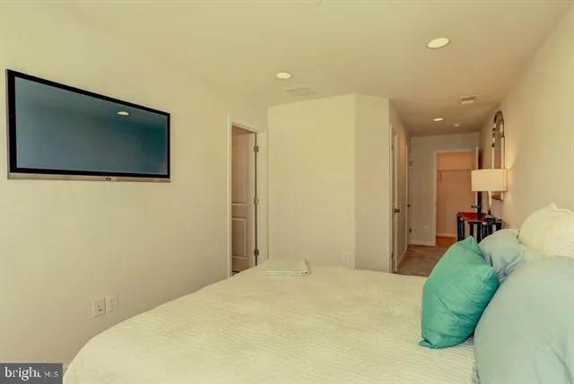 a bedroom with a bed and a flat screen tv
