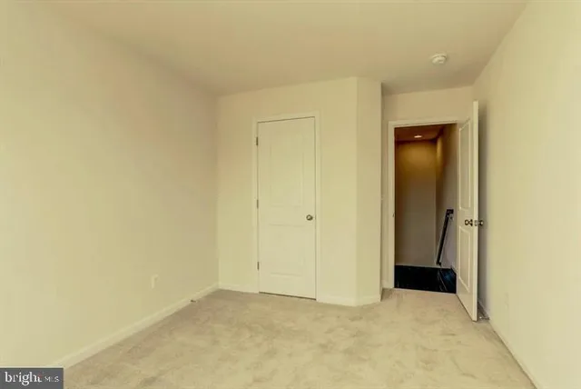 an empty room with closet and a bathroom