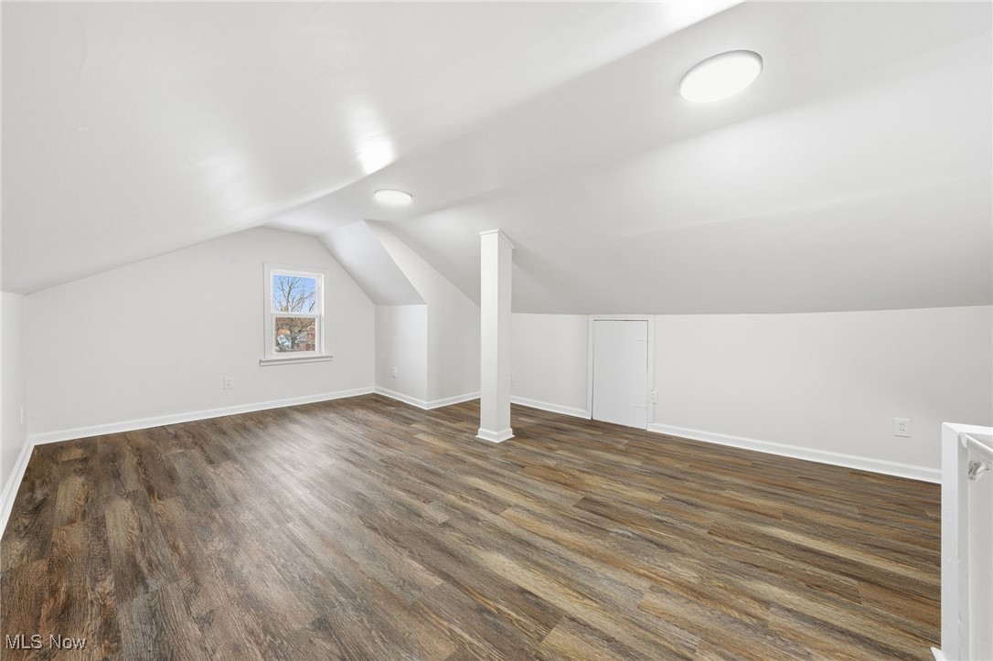 7911 Snow Road Parma, OH 44129 - Photo 29 of 44 Additional living space featuring dark wood-style floors and lofted ceiling