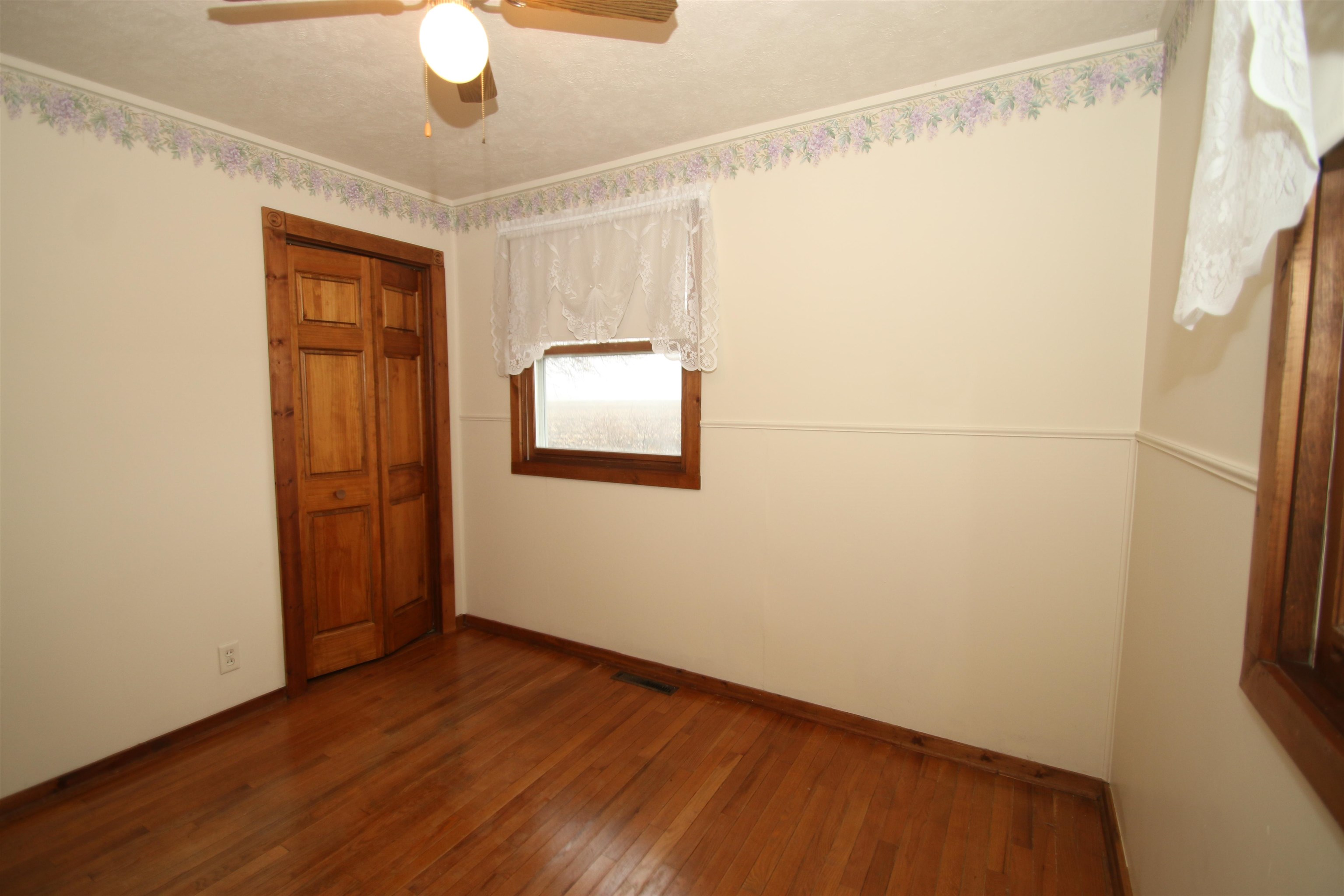 10926 Hill Road Garden Prairie, IL 61038 - Photo 24 of 53 a view of an empty room with wooden floor and a window