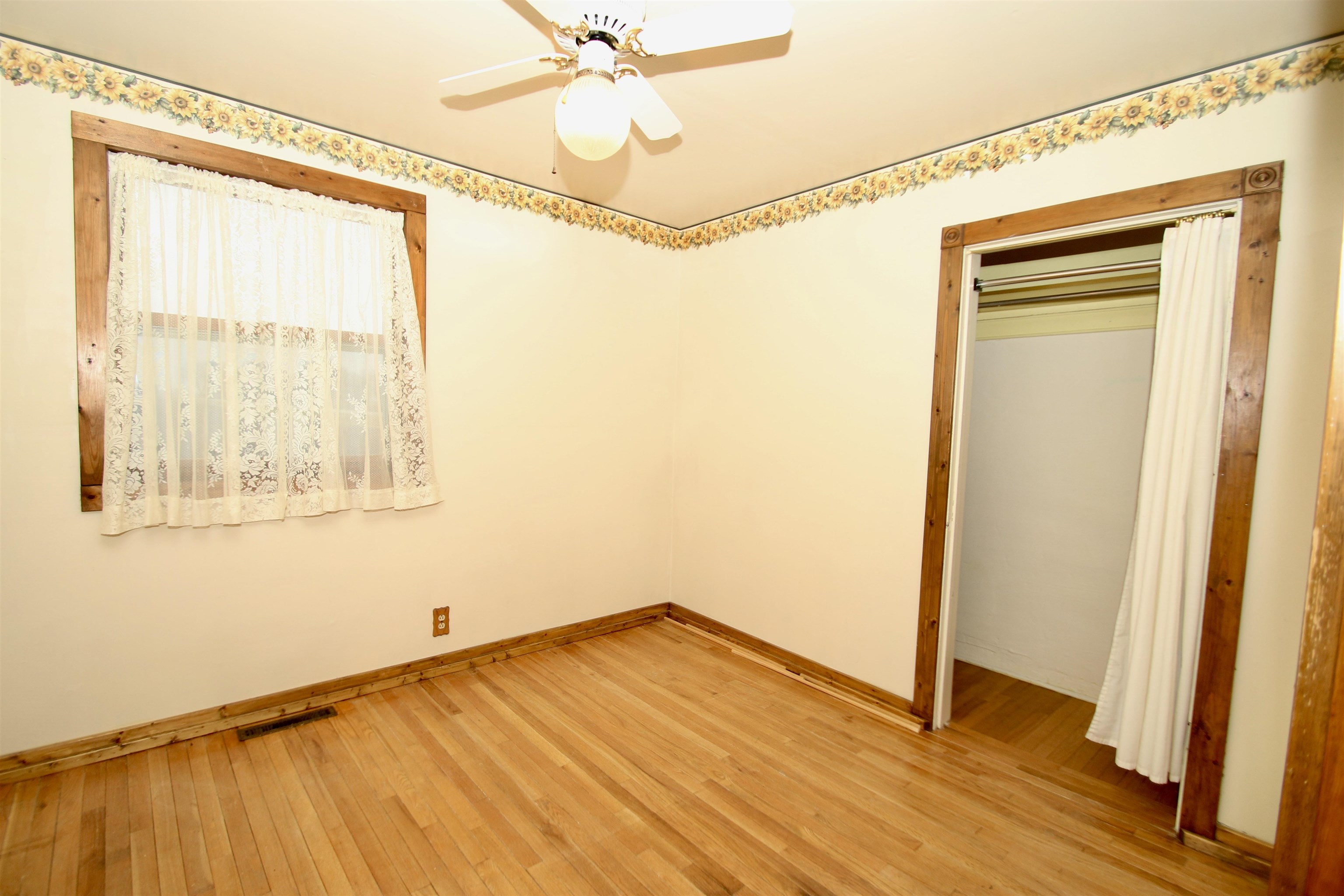 10926 Hill Road Garden Prairie, IL 61038 - Photo 26 of 53 a view of an empty room with wooden floor and a window