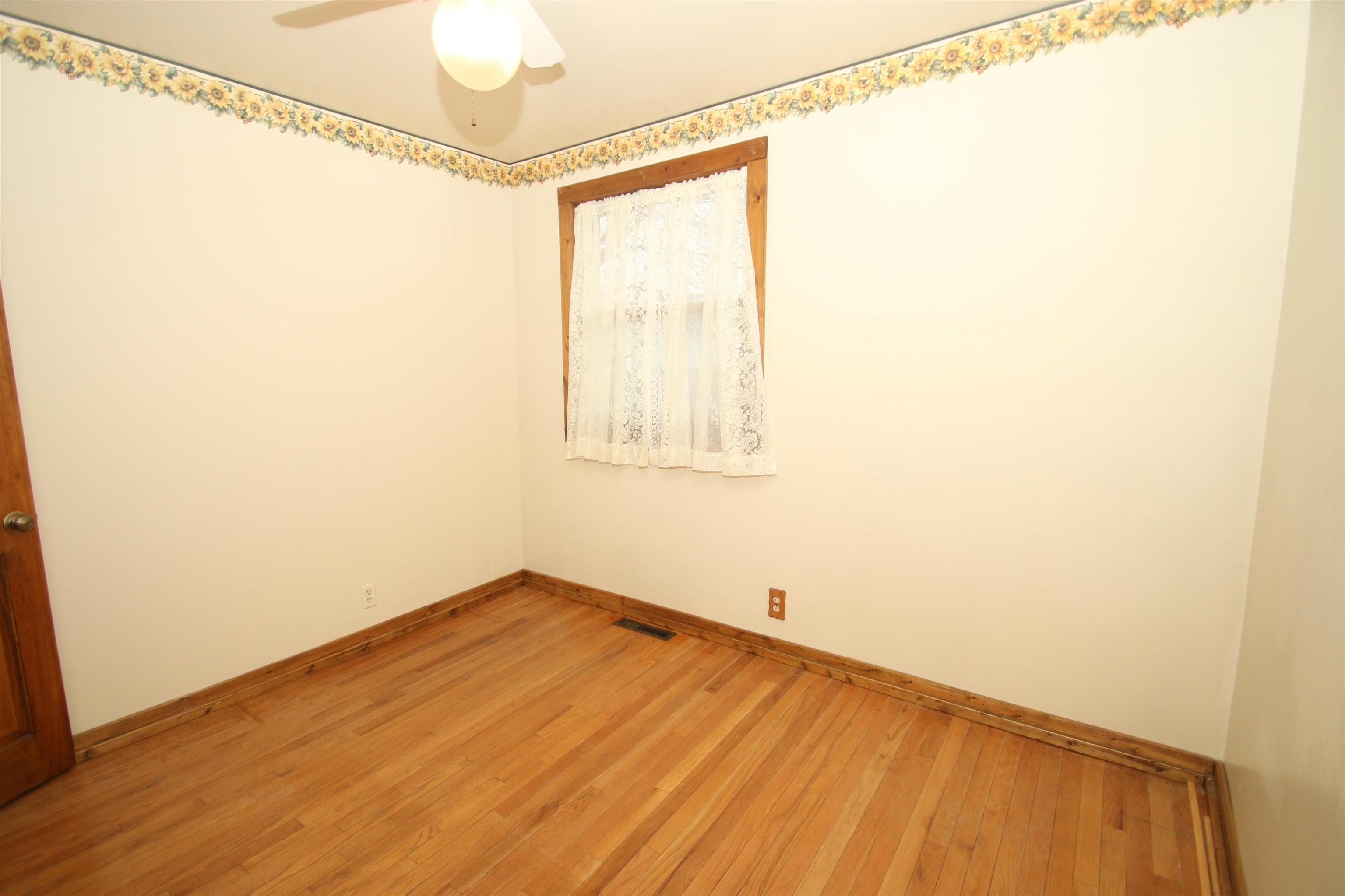 10926 Hill Road Garden Prairie, IL 61038 - Photo 27 of 53 a view of a room with wooden floor and small window