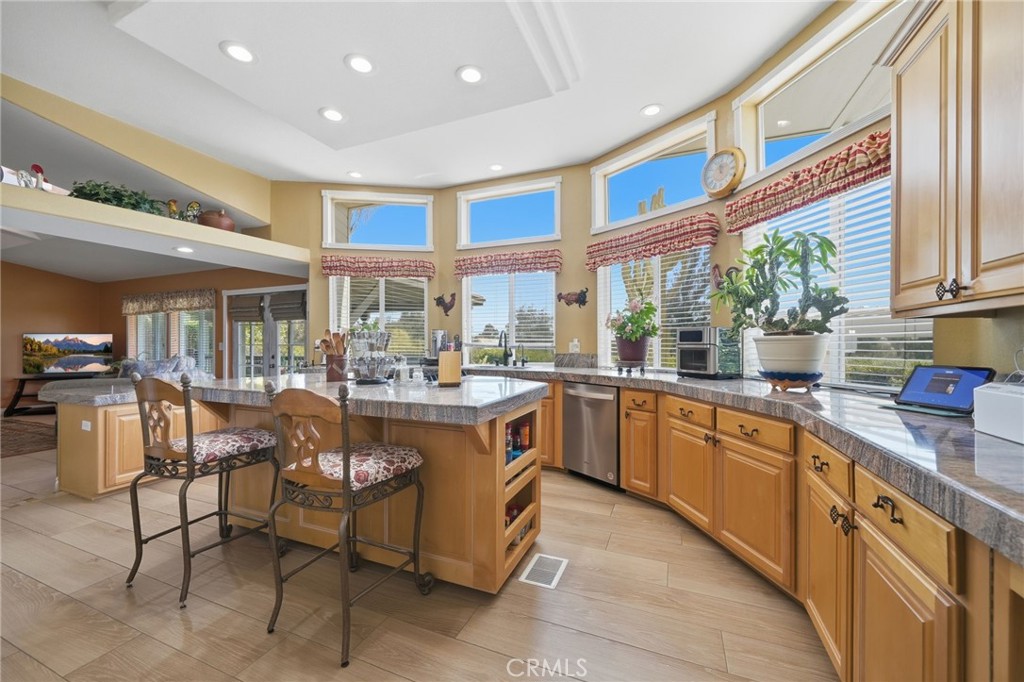 35780 Greer Road Murrieta, CA 92562 - Photo 7 of 56 Expansive kitchen w loads of cabinet space, granite countertops and amazing natural light from the bank of windows.