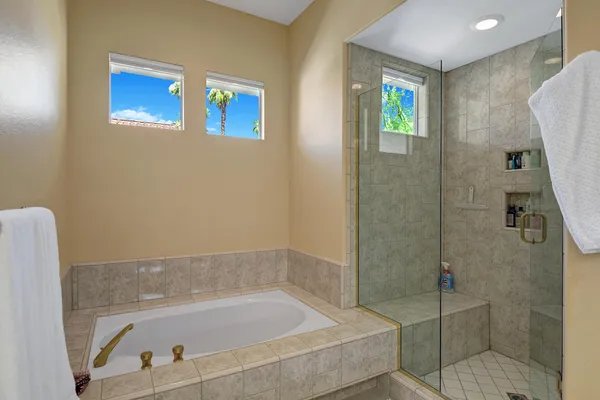 a bathroom with a bathtub and a shower