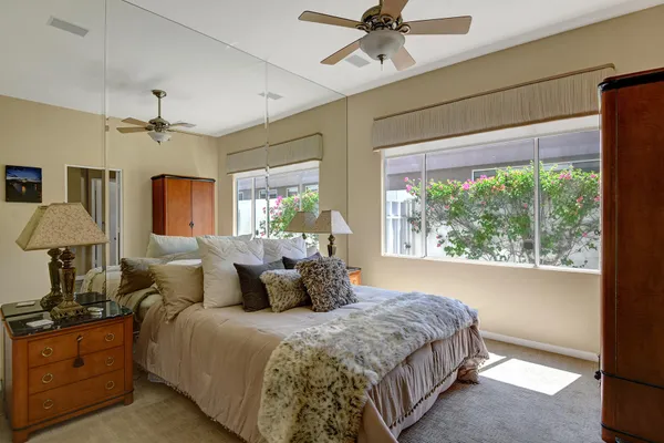 a bedroom with a large bed and a chandelier