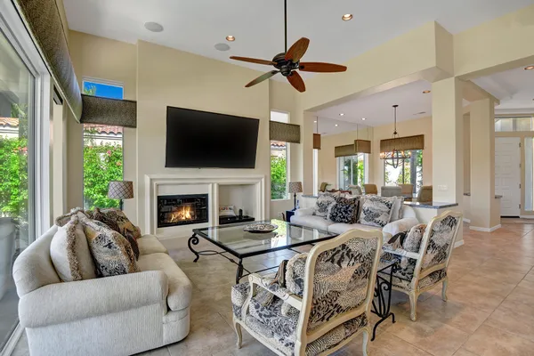 a living room with furniture a flat screen tv and a fireplace