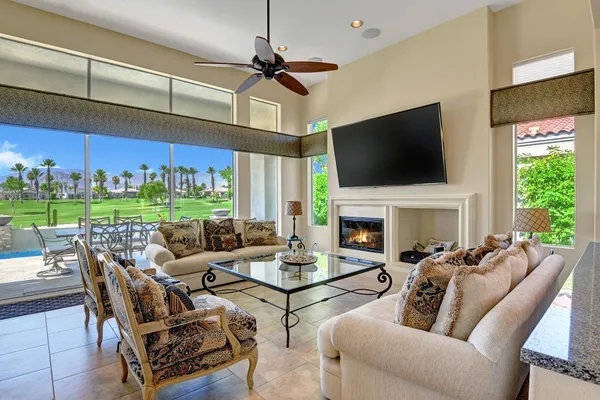 a living room with furniture a fireplace and a flat screen tv