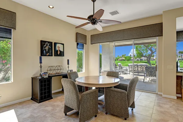a dining room with furniture and window