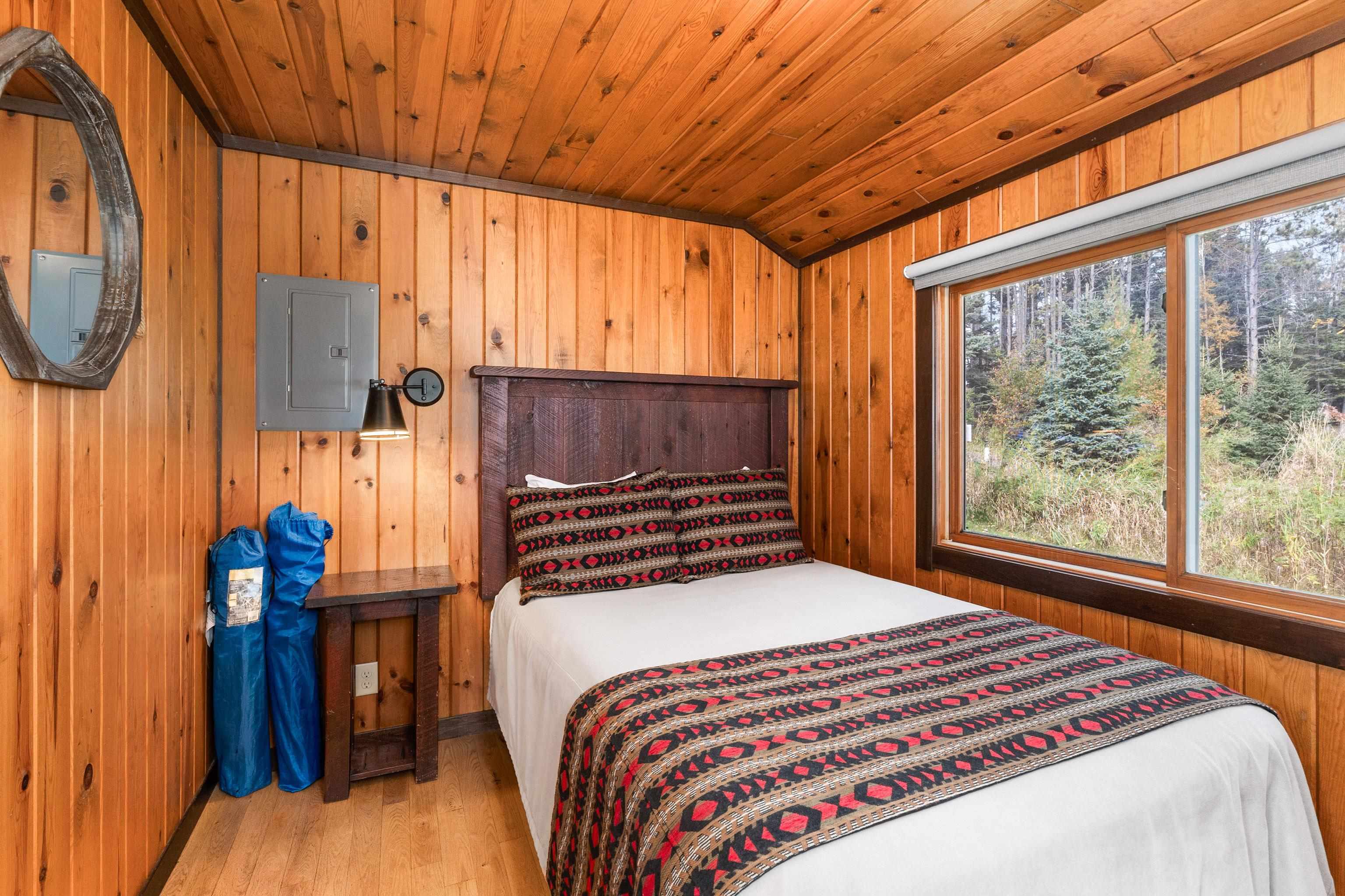 540 Old North Shore Road, Unit 7 Two Harbors, MN 55616 - Photo 27 of 61 Bedroom featuring wooden walls, wood finished floors, electric panel, and wood ceiling