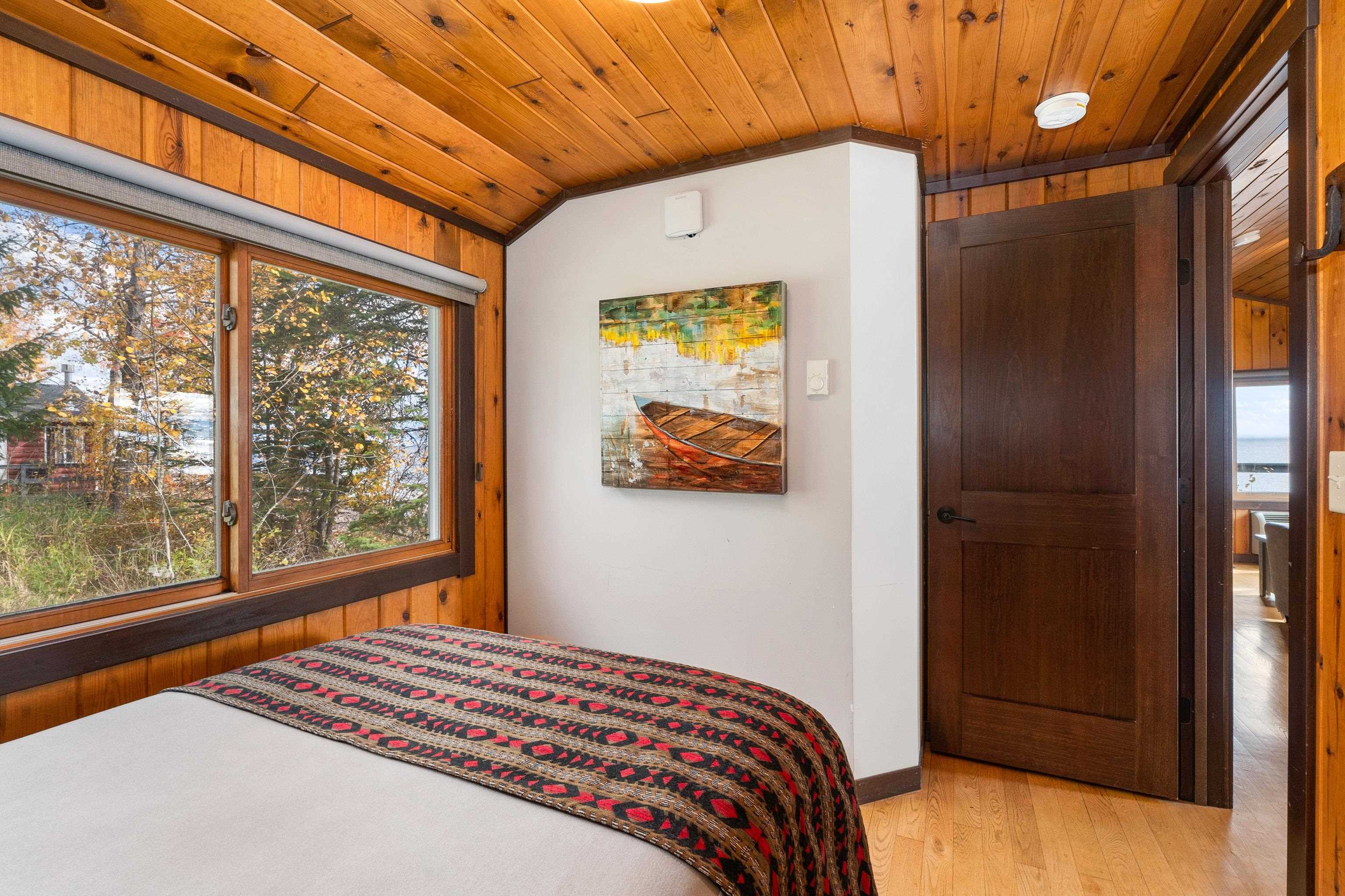 540 Old North Shore Road, Unit 7 Two Harbors, MN 55616 - Photo 28 of 61 Bedroom with light wood-style floors, vaulted ceiling, wooden walls, and wood ceiling