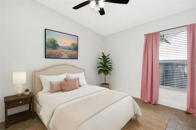 a bedroom with a large bed and a chandelier