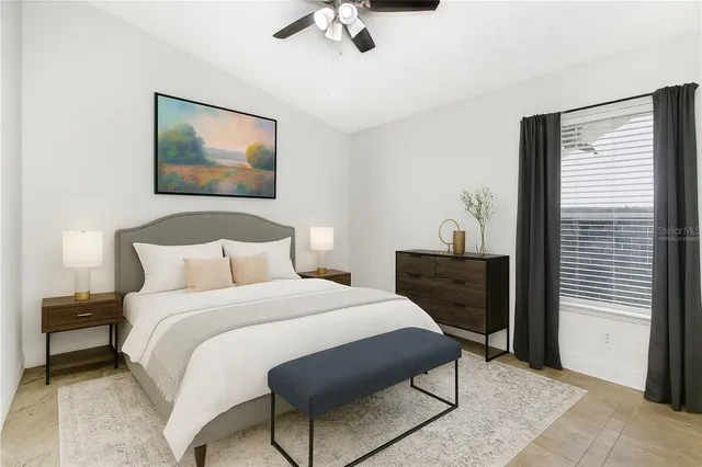 a bedroom with a bed and a painting on the wall