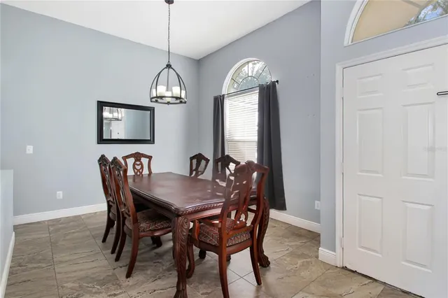 a view of a dining room with furniture and chandelier