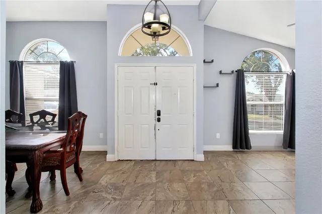a dining room with furniture and window