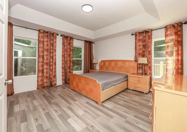 a bedroom with a large bed and a large window