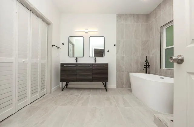 a bathroom with a bathtub a sink and a mirror