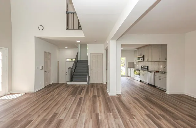 a view of a kitchen with wooden floor and a sink