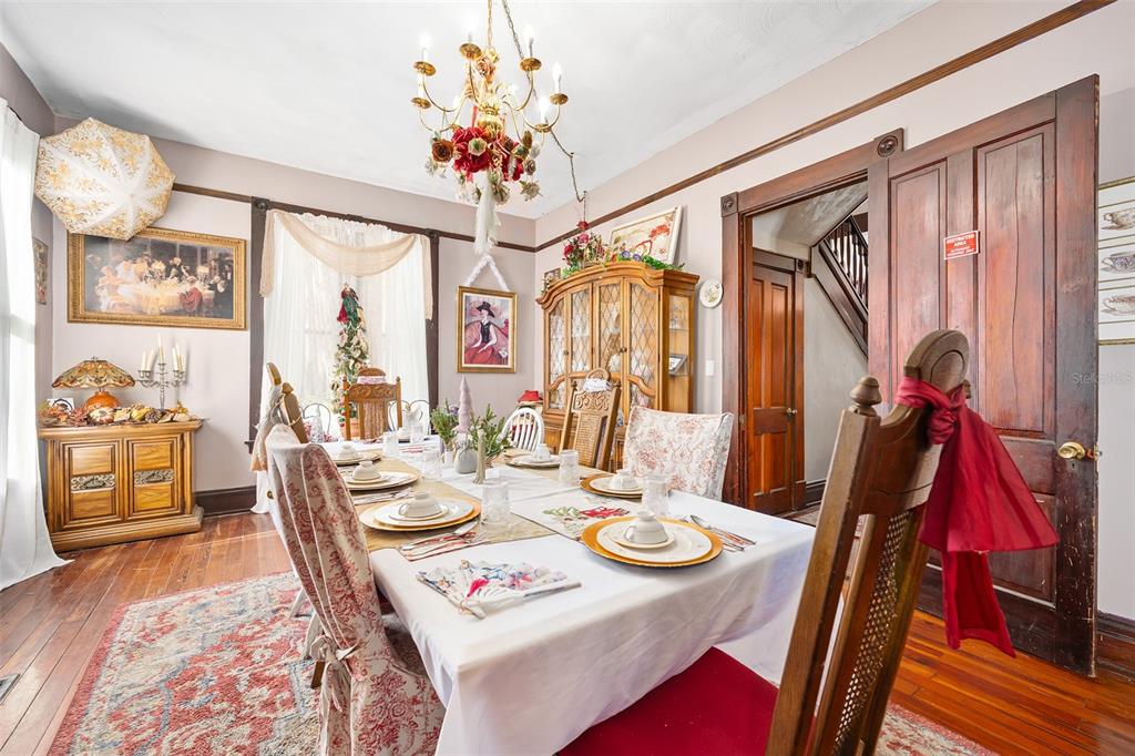 228 West Howry Avenue DeLand, FL 32720 - Photo 12 of 55 a view of a dining room with furniture window and wooden floor