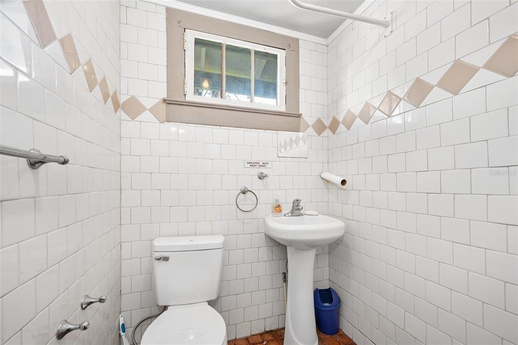 228 West Howry Avenue DeLand, FL 32720 - Photo 17 of 55 a bathroom with a sink toilet and a mirror