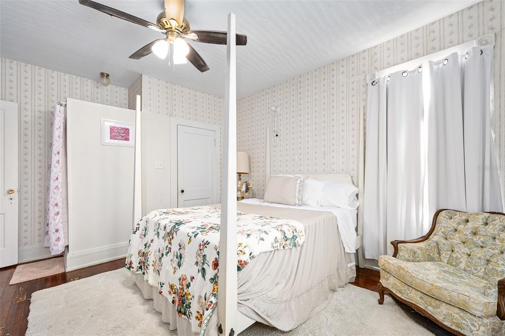 228 West Howry Avenue DeLand, FL 32720 - Photo 26 of 55 a bedroom with a bed and a couch