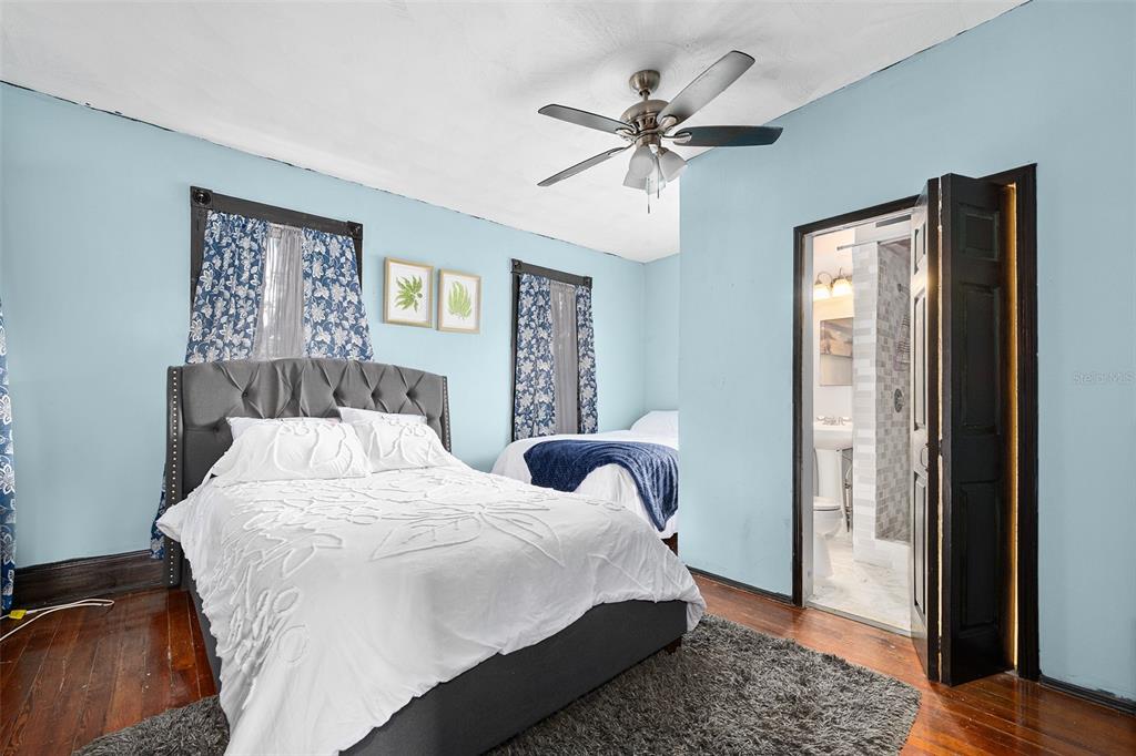 228 West Howry Avenue DeLand, FL 32720 - Photo 27 of 55 a bedroom with a large bed and a window