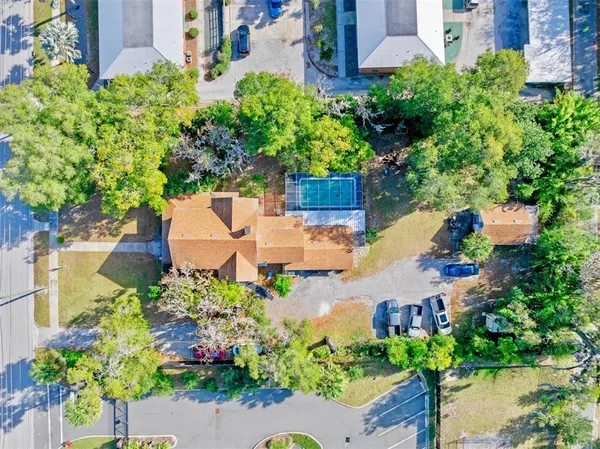 an aerial view of a house with a garden and lake view