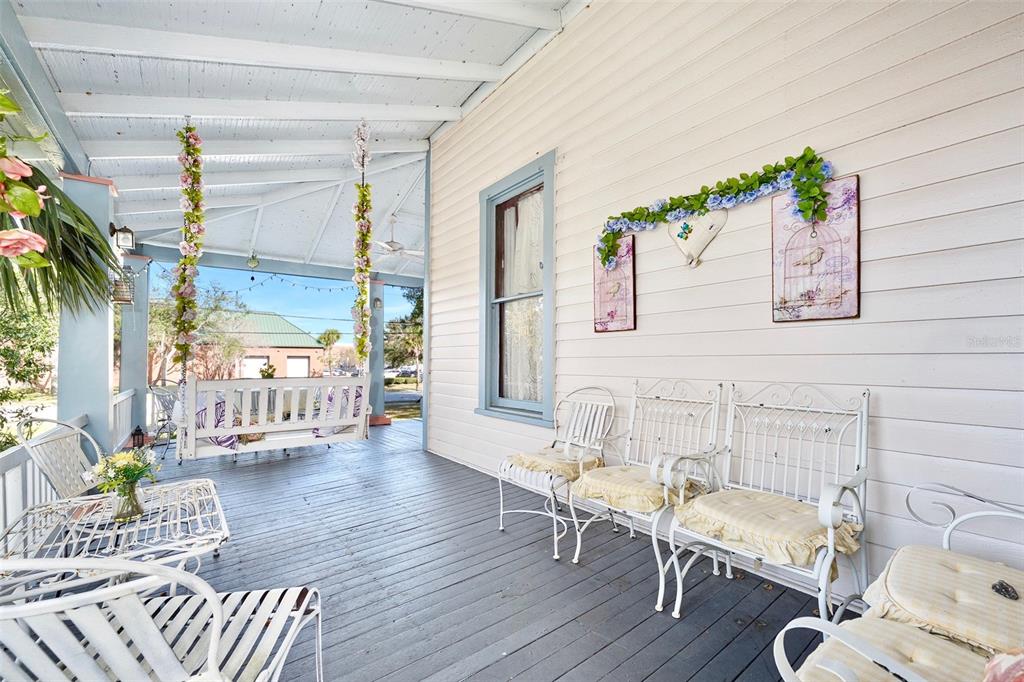 228 West Howry Avenue DeLand, FL 32720 - Photo 42 of 55 a balcony with furniture and a potted plant