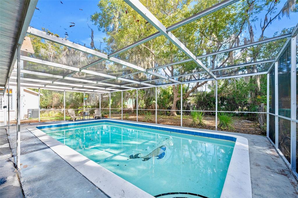 228 West Howry Avenue DeLand, FL 32720 - Photo 43 of 55 a view of a swimming pool with a patio and a yard