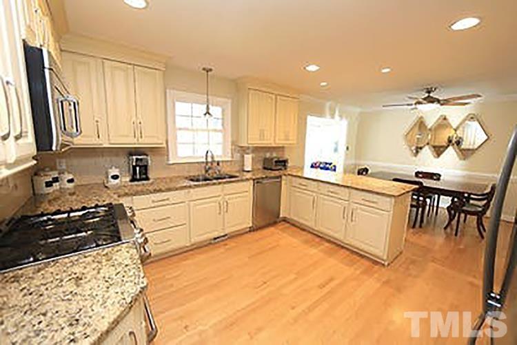 4229 Rowan Street Raleigh, NC 27609 - Photo 12 of 30 a kitchen with a sink a stove and cabinets