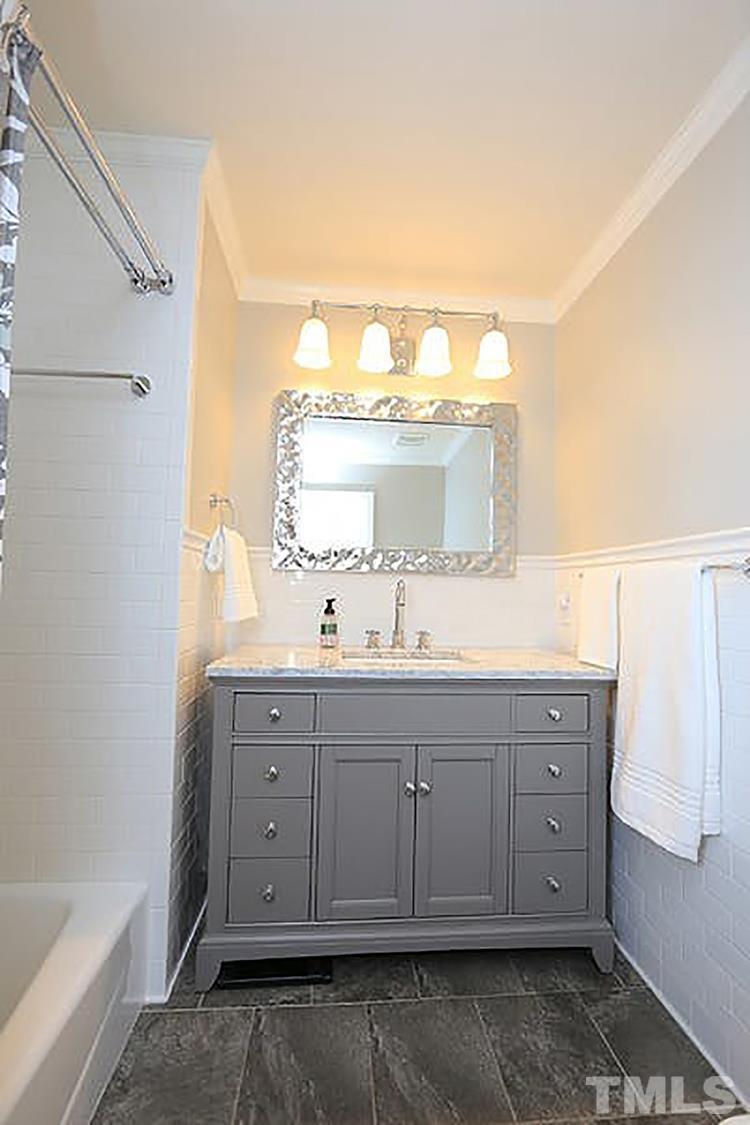 4229 Rowan Street Raleigh, NC 27609 - Photo 20 of 30 a bathroom with a double vanity sink and mirror