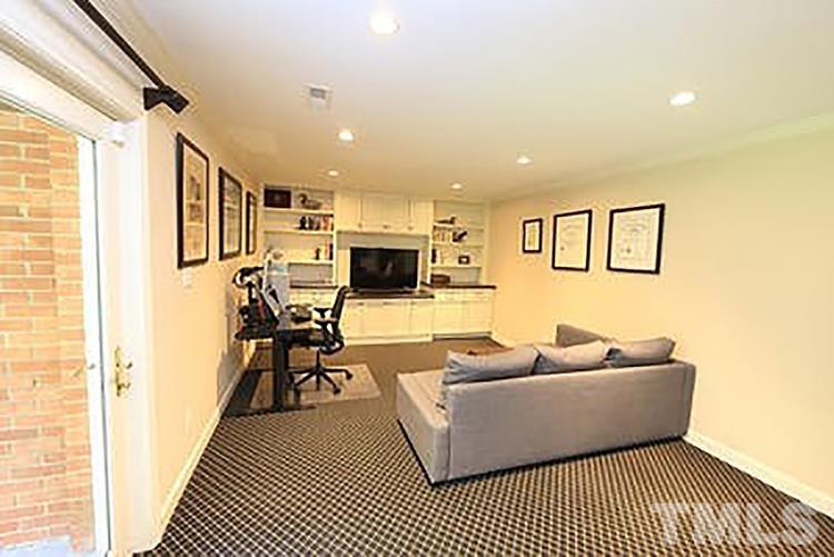 4229 Rowan Street Raleigh, NC 27609 - Photo 21 of 30 a living room with furniture a flat screen tv and a window