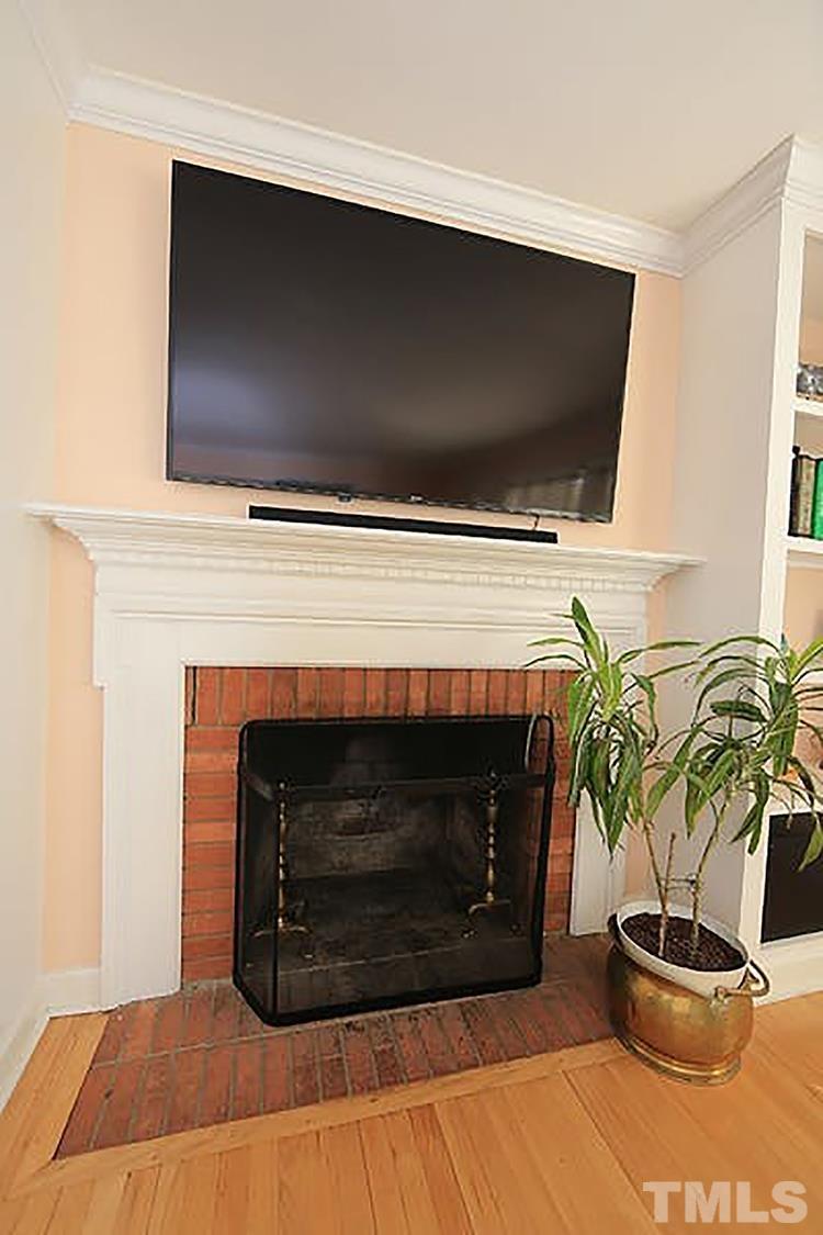 4229 Rowan Street Raleigh, NC 27609 - Photo 5 of 30 a living room with a fireplace and a potted plant