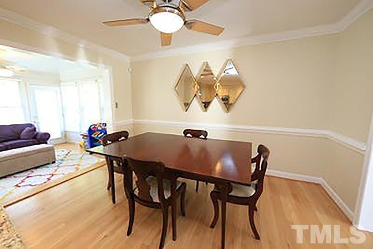 4229 Rowan Street Raleigh, NC 27609 - Photo 8 of 30 a view of a dining room with furniture and chandelier