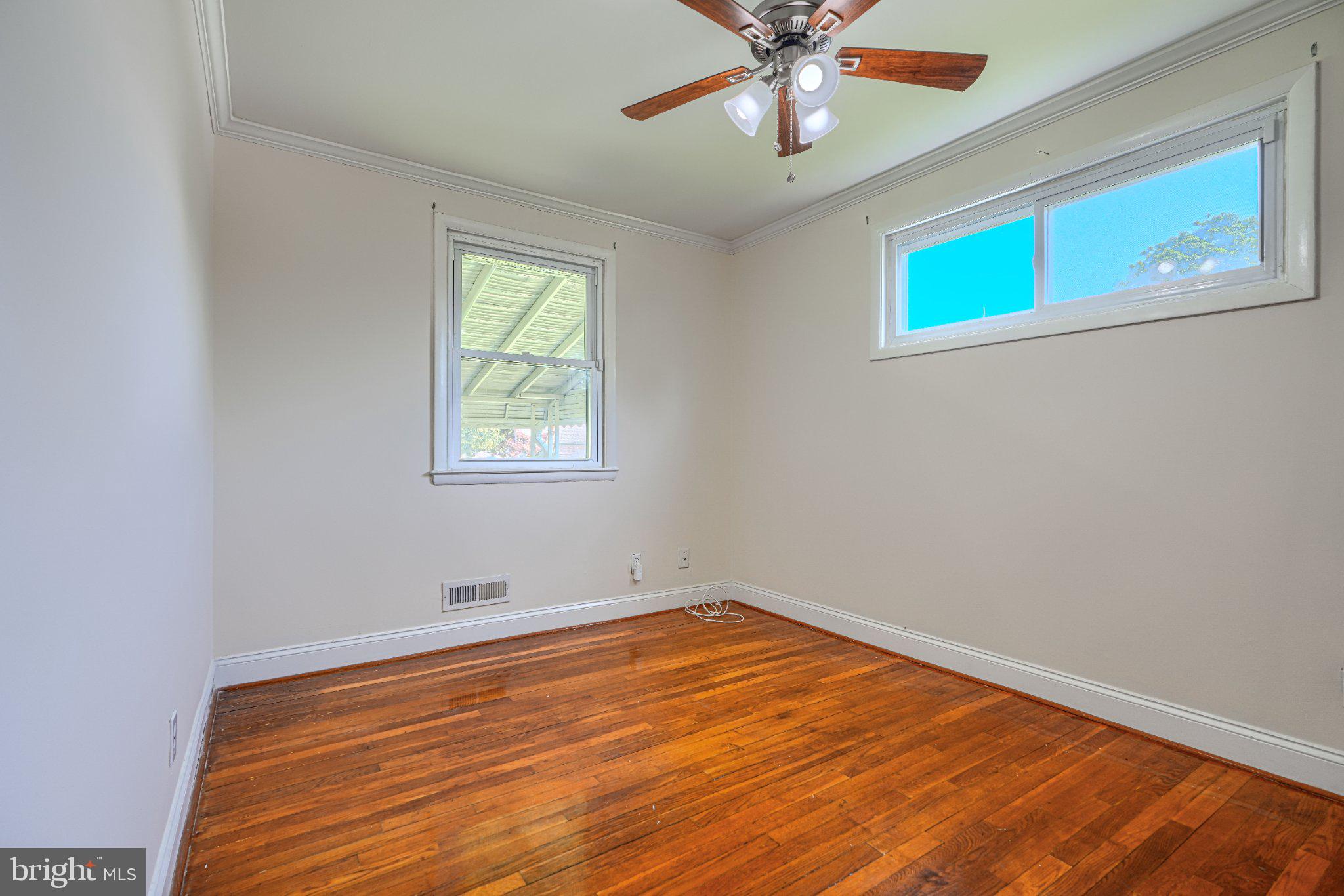 3708 Cassen Road Randallstown, MD 21133 - Photo 14 of 38 a view of an empty room with wooden floor and a window