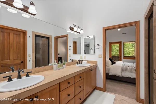 a en suite bathroom with a double vanity sink and a mirror