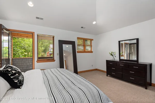 a bedroom with a bed and a large window