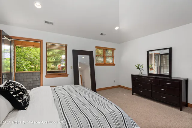 a bedroom with a bed and a large window