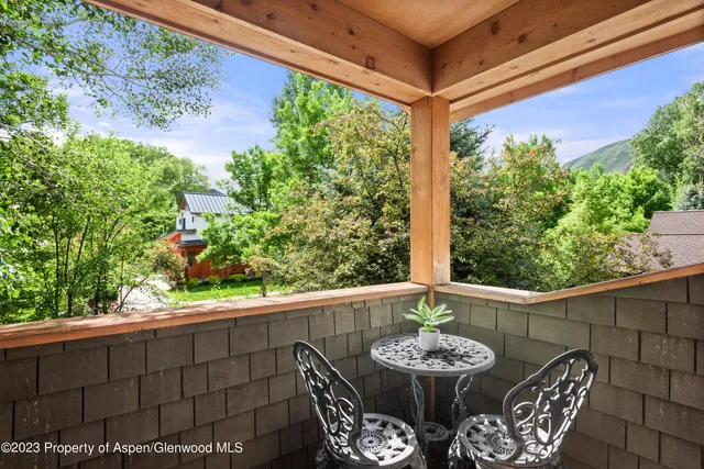 a view of a patio with a table and chairs