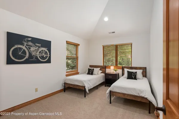 a bedroom with two beds and a window