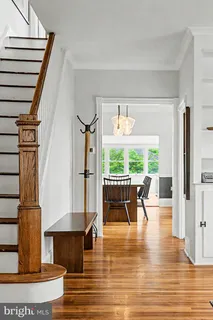 a view of dining room with furniture window and wooden floor