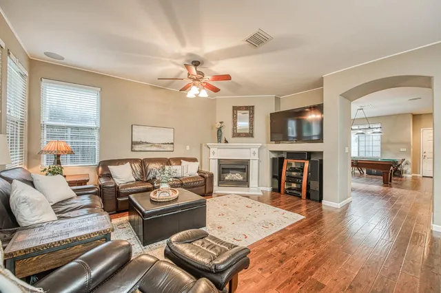 a living room with furniture a fireplace and a flat screen tv