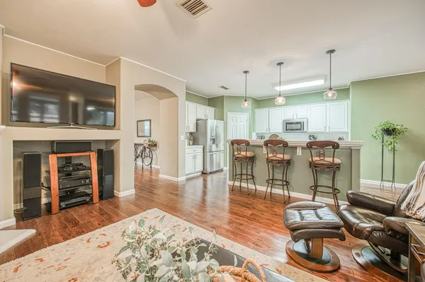 a room with lots of chairs and wooden floor